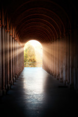 Arched corridor illuminated by the sun