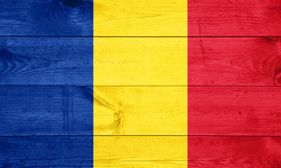 Flag of Romania painted on grungy wood plank background