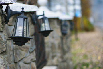 street lights on a stone fence