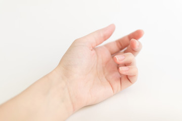 Close up woman hand with nails form of soft square holds something in fingers. Female keeps virtual object. Nail care at home.