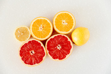 Half of grapefruit, orange, lemon cut for fresh juice. Color splash. Tropical fruits