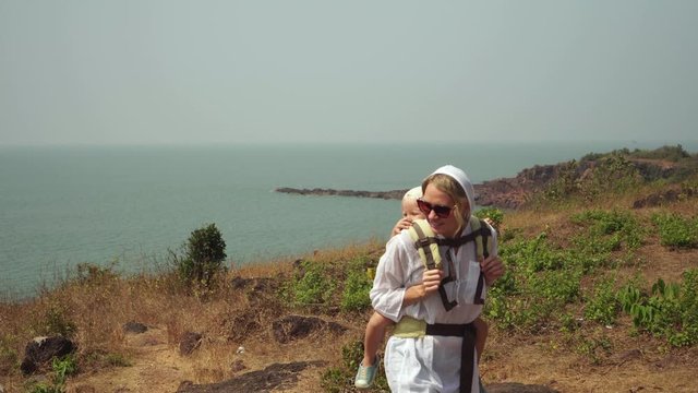 Woman tourist travels with a child. Woman tourist with a small child in nature
