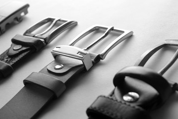 belts on a white background. leather belt with a metal buckle