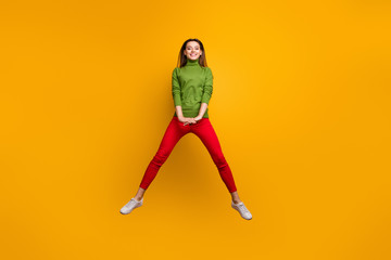 Fototapeta na wymiar Full length photo of positive cheerful girl enjoy winter vacation jump wear casual style modern outfit isolated over bright color background