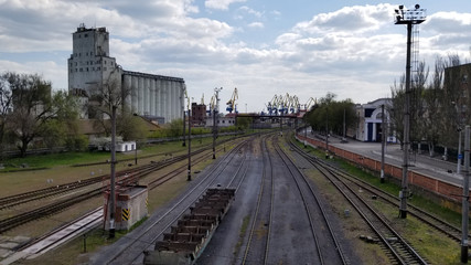 Fototapeta premium A line of railroad train tanker cars. Industrial Zone. empty wagons. Point on top