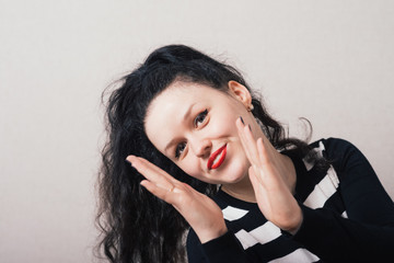 Woman claps fun. Gray background.
