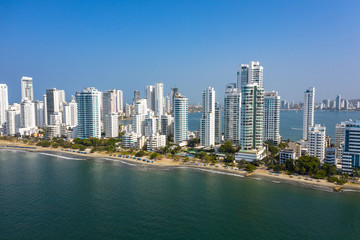 Fototapeta premium Aerial View of the hotels and tall apartment buildings near the Caribbean coast. Modern City Skyline.