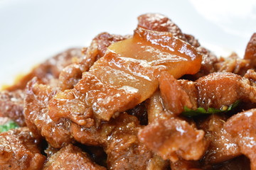 fried slice pork belly in sweet gravy sauce on dish