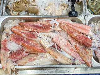 Heap of squids and octopus for sale at seafood store