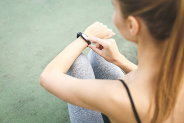 Woman setting up the fitness smart watch for running. Sportswoman checking watch device. Close-Up....