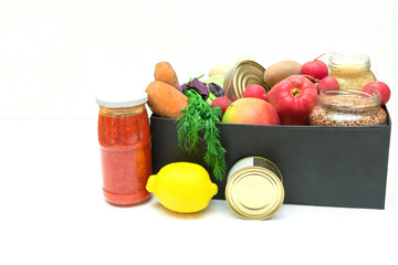 supplies food help box full of vegetables, canned, cereal, eggs and fruits. donation box for delivery charity with copy space. coronavirus volunteer donation isolated on white background