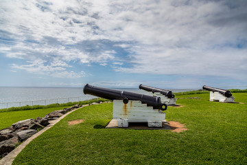 Kiama in Victoria, Australia - 13th February 2020: A german photographer visiting the Kiama Blow Hole landmark, taking pictures of the surroundings including historical canons.