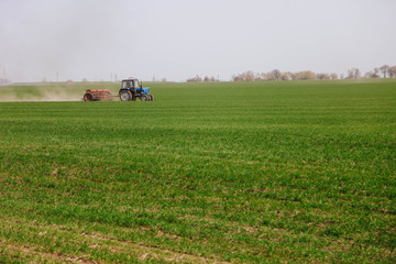 Obraz premium The tractor works in the field.