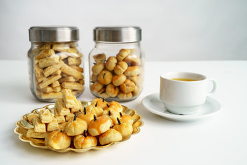 Delicious snack for breaking the fast. traditional islamic snack asian nastar served with tea over white