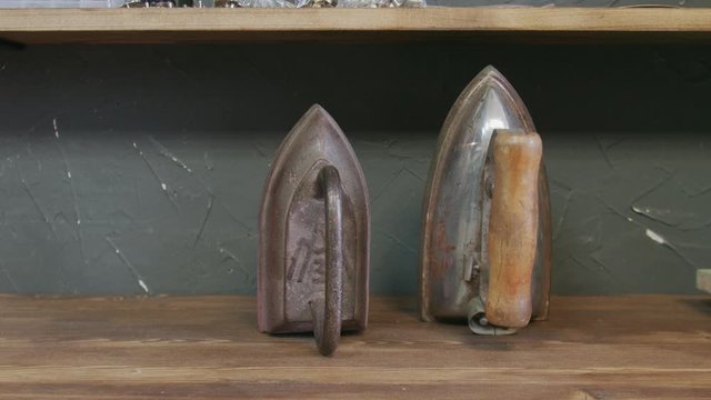 Two decorative old iron on a shelf