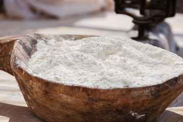 Flour in a wooden dish in selective focus