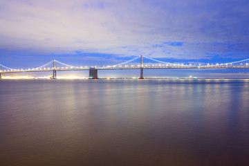 View of the illuminated san francisco-oakland bay bridge at night, San Francisco, California, United States
