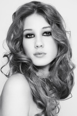 Black and white portrait of young beautiful girl with curly hair