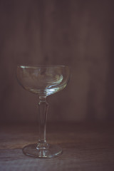 Empty coupe glass on vintage background