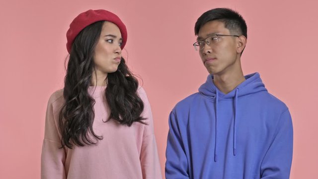 Young Displeased Loving Couple Isolated Over Pink Wall Background Says No.