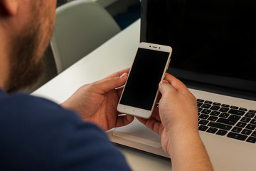 A man sitting in front of a laptop computer
