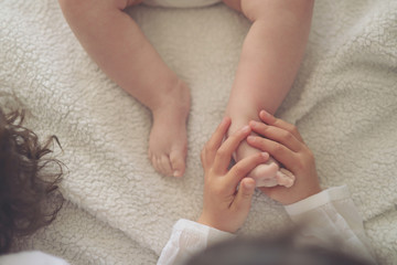 The boy welcomes his brother home with his feet.