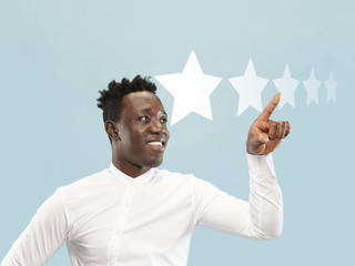 Man touching five star symbol to increase rating of company, app or service. Leaves his rate for...