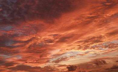 The orange sky is clouded by ocean waves that occur before sunrise in the morning.