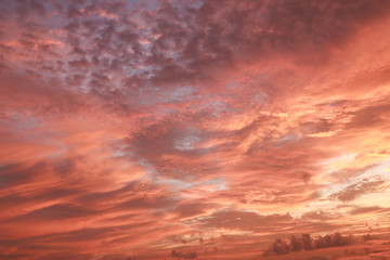 The orange sky is clouded by ocean waves that occur before sunrise in the morning.