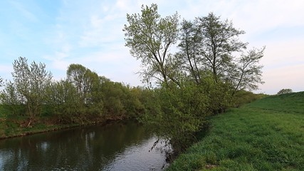 River-basin of Nitra river, central Slovakia, during spring season, surrounded by tree lanes and green vegetation. Location western Slovakia, central Europe. 