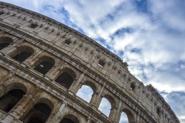 Fototapeta premium Colosseum in Rome, Italy. Ancient Roman Colosseum is one of the main tourist attractions in Europe. People visit the famous Colosseum in Roma center. Scenic view of Colosseum ruins.