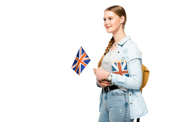 smiling pretty student with backpack holding book and British flag isolated on white