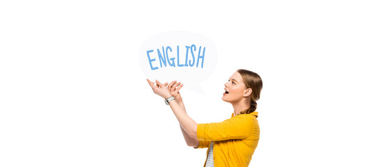 side view of excited pretty girl with braid holding speech bubble with English lettering isolated...