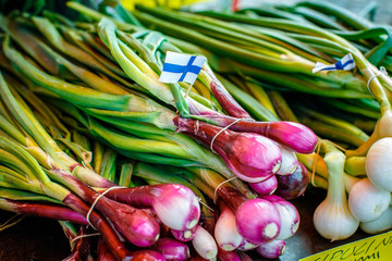 green onions with Finnish flag on local food market in Helsinki, Finland