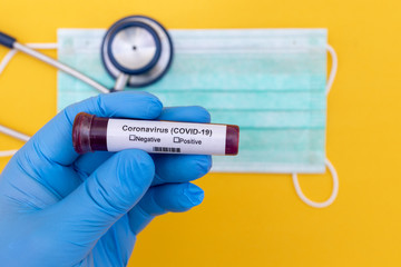 Coronavirus (COVID-19) testng concept, Hand holds a test tube containing a blood sample.