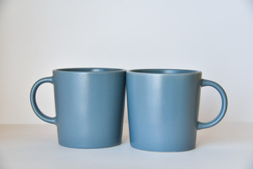 two coffee cups on a white table in a bright kitchen