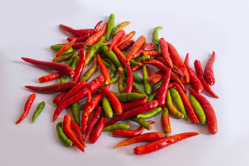 Separate chilli fruit that has a red-green color on a white background