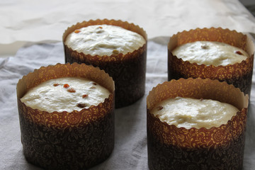 Dough for raisin cupcakes in a paper form for baking. Homemade cake. Concept of homework during the quarantine period.