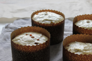 Dough for raisin cupcakes in a paper form for baking. Homemade cake. Concept of homework during the quarantine period.