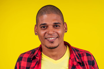arabic brazilian man posing at studio in yellow background