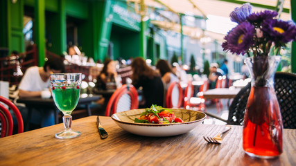 Summer terrace table with dishes and glass guests