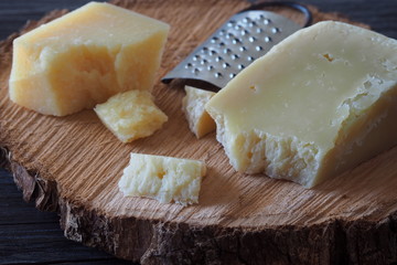 Pecorino cheese and Parmesan cheese on a rustic wooden table.