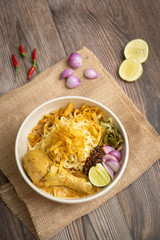 Khao Soi Chicken, Northern Thai Food on the wooden table - Stock photo