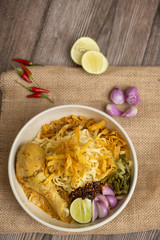 Khao Soi Chicken, Northern Thai Food on the wooden table - Stock photo