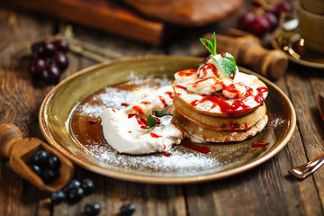 breakfast sweet pancakes with sauce and cream