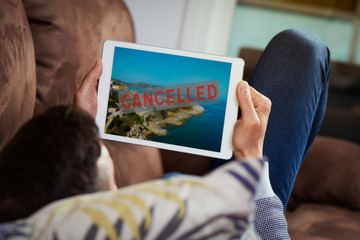 man and tablet with the text cancelled in it