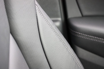 Close up of black leather car seat