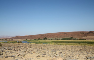 Fototapeta na wymiar River flowing in the desert