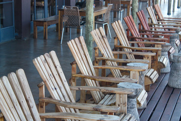 Line of wooden sun lounger chairs