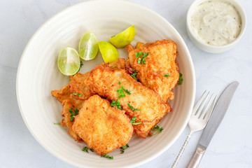 Delicious Fried Fish with in a Plate with Lemon and White Dip Sauce, Fish Appetizer Horizontal Top Down Photo on White Background